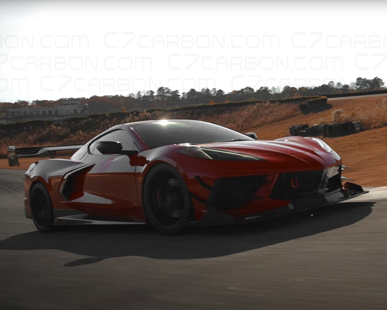 A red Corvette C8 on the road, fitted with a Legacy Edition front splitter and side canards for improved downforce.