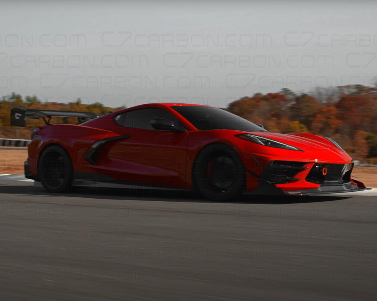 Red Corvette C8 on a racetrack, with a mounted rear spoiler for added downforce.