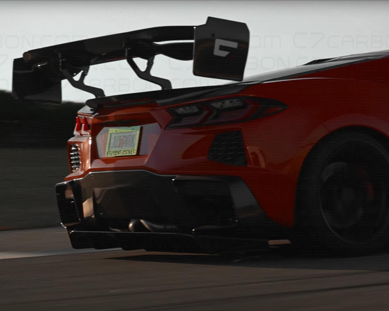 Rear view of a red Corvette C8 showcasing its mounted victory class rear spoiler.