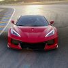 Front view of Corvette C8 with C8R Style Wide Body Kit on track during sunset