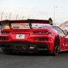 Rear view of a Corvette C8 Z06 ERAY ZR1 with carbon fiber spoiler, parked on a race track